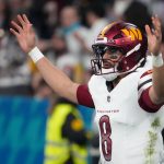 Nov 16, 2025; Madrid, Spain; Washington Commanders quarterback Marcus Mariota (8) reacts after a play against the Miami Dolphins in the third quarter during the 2025 NFL Madrid Game at Santiago Bernabeu Stadium.
