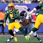 Nov 16, 2025; East Rutherford, New Jersey, USA; Green Bay Packers running back Josh Jacobs (8) runs the ball against New York Giants defensive tackle Roy Robertson-Harris (95) during the first quarter at MetLife Stadium. Mandatory Credit: Vincent Carchietta-Imagn Images