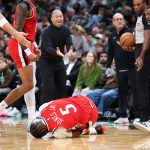 Nov 16, 2025; Boston, Massachusetts, USA; Los Angeles Clippers forward Derrick Jones Jr (5) grabs his knee during the first half against the Boston Celtics at TD Garden. Mandatory Credit: Paul Rutherford-Imagn Images