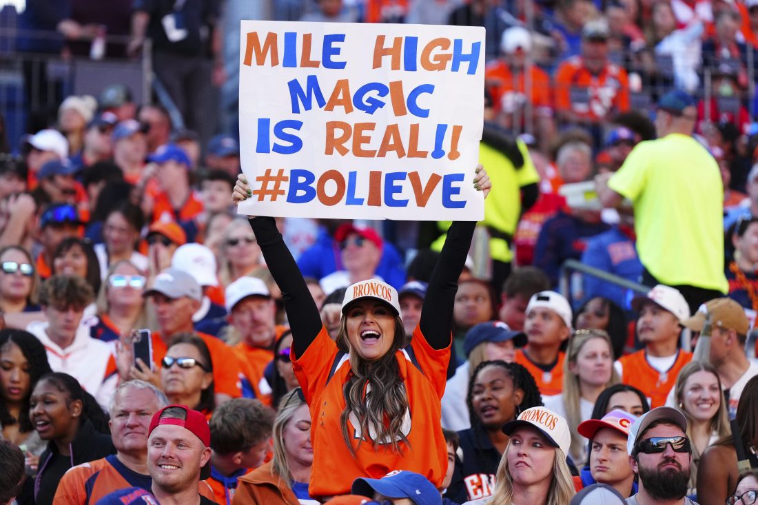 Nov 16, 2025; Denver, Colorado, USA; A Denver Broncos fan holds a sign during the first quarter of the game against the Kansas City Chiefs at Empower Field at Mile High. Mandatory Credit: Ron Chenoy-Imagn Images