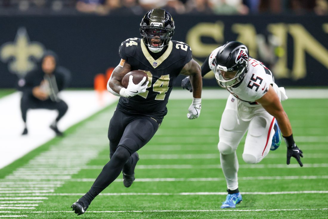 Nov 23, 2025; New Orleans, Louisiana, USA; New Orleans Saints running back Devin Neal (24) carries the ball as Atlanta Falcons linebacker Kaden Elliss (55) defends during the second half at Caesars Superdome.