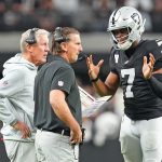 Nov 23, 2025; Paradise, Nevada, USA; Las Vegas Raiders quarterback Geno Smith (7) talks with head coach Pete Carroll and quarterbacks coach Greg Olsen in a game against the Cleveland Browns during the fourth quarter at Allegiant Stadium.