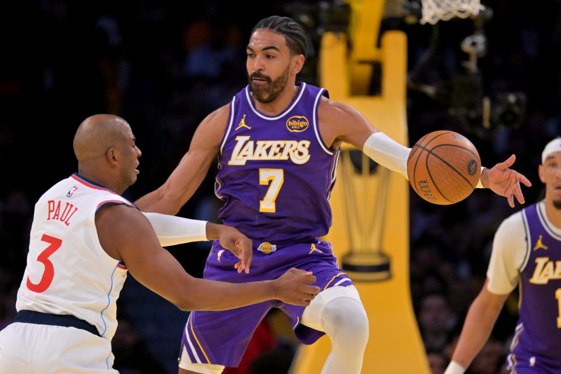 Nov 25, 2025; Los Angeles, California, USA; Los Angeles Lakers guard Gabe Vincent (7) defends a pass by Los Angeles Clippers guard Chris Paul (3) in the first half at Crypto.com Arena. Mandatory Credit: Jayne Kamin-Oncea-Imagn Images