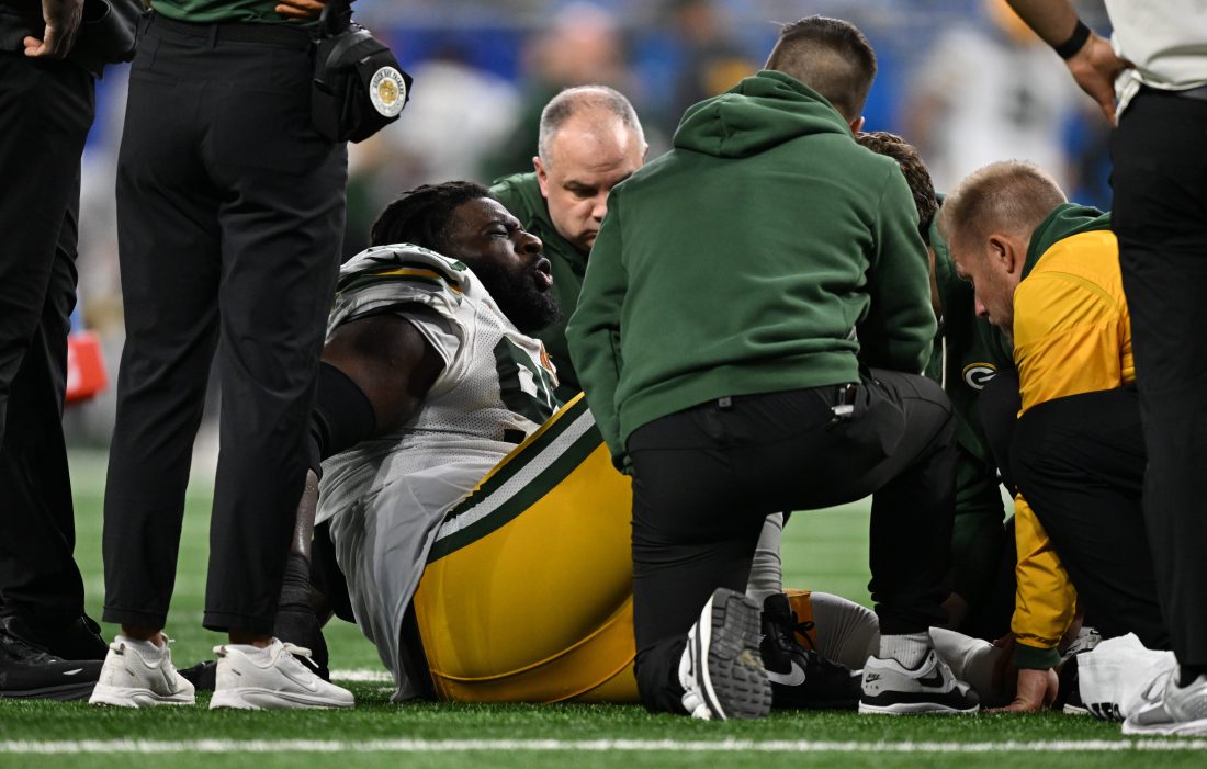 Nov 27, 2025; Detroit, Michigan, USA; Green Bay Packers defensive tackle Devonte Wyatt (95) is looked at after an injury against the Detroit Lions during the third quarter at Ford Field. Mandatory Credit: Lon Horwedel-Imagn Images
