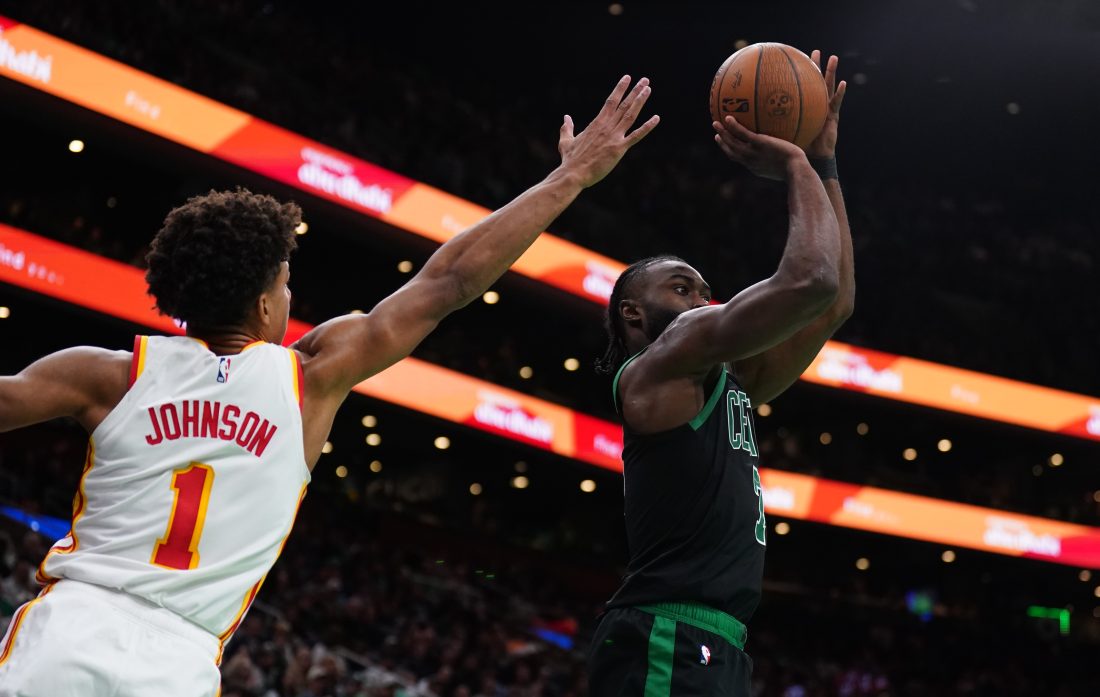 Nov 12, 2024; Boston, Massachusetts, USA; Boston Celtics guard Jaylen Brown (7) shoots for three points against Atlanta Hawks forward Jalen Johnson (1) in the second half at TD Garden. Mandatory Credit: David Butler II-Imagn Images