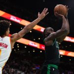 Nov 12, 2024; Boston, Massachusetts, USA; Boston Celtics guard Jaylen Brown (7) shoots for three points against Atlanta Hawks forward Jalen Johnson (1) in the second half at TD Garden. Mandatory Credit: David Butler II-Imagn Images
