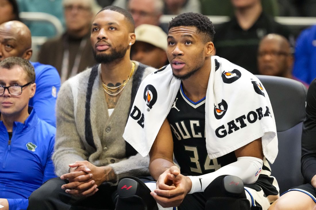 Nov 12, 2024; Milwaukee, Wisconsin, USA; Milwaukee Bucks forward Giannis Antetokounmpo (34) sits with guard Damian Lillard on the bench during the fourth quarter against the Toronto Raptors at Fiserv Forum. Mandatory Credit: Jeff Hanisch-Imagn Image
