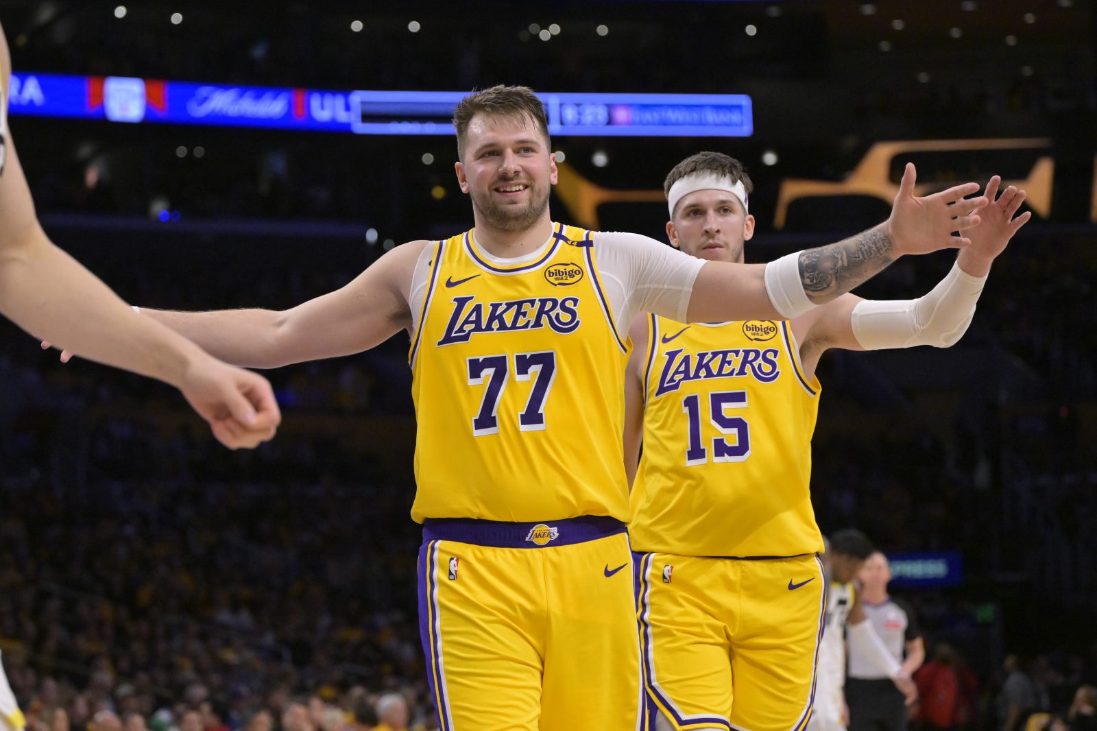 Feb 10, 2025; Los Angeles, California, USA; Los Angeles Lakers guard Luka Doncic (77) and guard Austin Reaves (15) react after a basket against the Utah Jazz at Crypto.com Arena. Mandatory Credit: Jayne Kamin-Oncea-Imagn Images