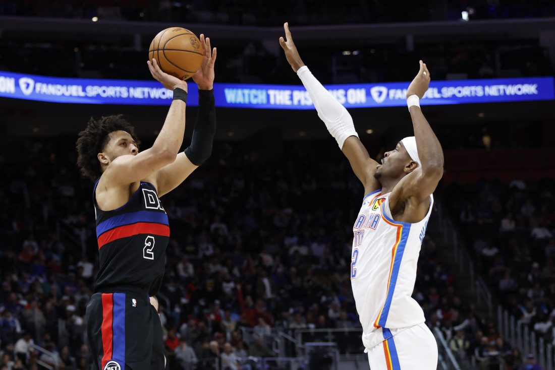 Mar 15, 2025; Detroit, Michigan, USA; Detroit Pistons guard Cade Cunningham (2) shoots on Oklahoma City Thunder guard Shai Gilgeous-Alexander (2) in the first half at Little Caesars Arena.
