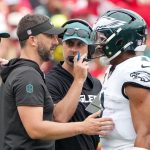 Sep 14, 2025; Kansas City, Missouri, USA; Philadelphia Eagles head coach Nick Sirianni and offenisve coordinator Kevin Patullo speak with Philadelphia Eagles quarterback Jalen Hurts (1) during the second quarter of the game against the Kansas City Chiefs at GEHA Field at Arrowhead Stadium. Mandatory Credit: Denny Medley-Imagn Images