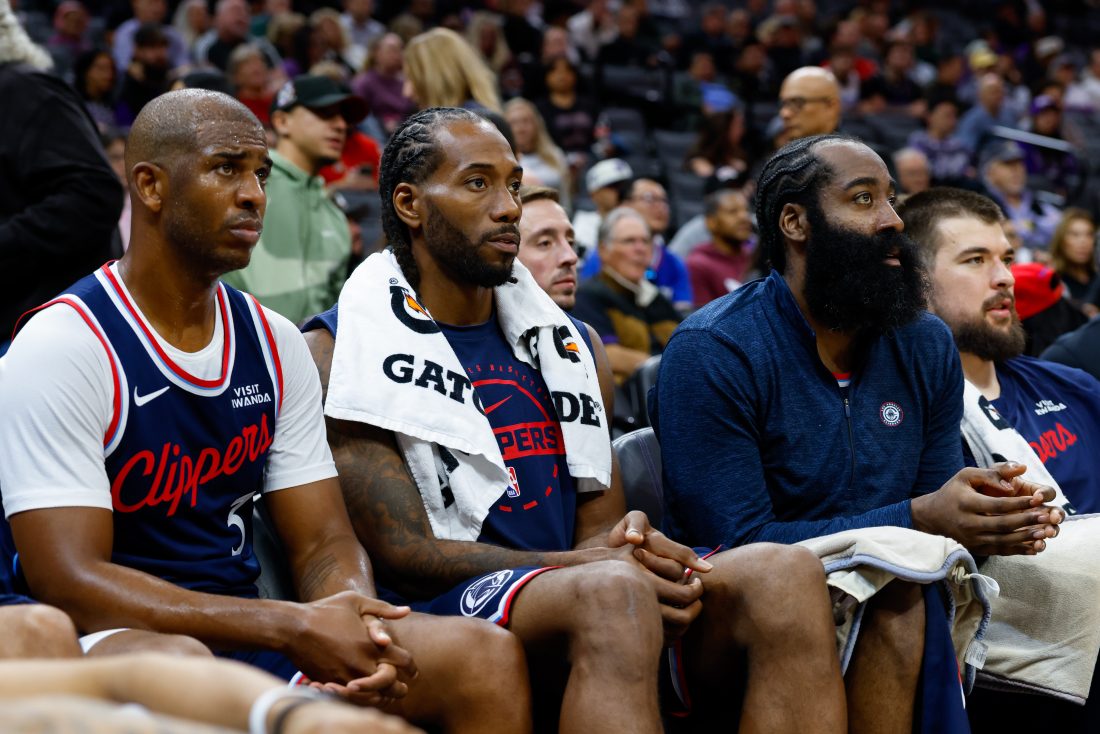 Oct 15, 2025; Sacramento, California, USA; Los Angeles Clippers guard Chris Paul (3) and forward Kawhi Leonard (2) and guard James Harden (1) sit on the bench during the fourth quarter against the Sacramento Kings at Golden 1 Center.