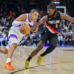 Oct 16, 2025; Salt Lake City, Utah, USA; Utah Jazz guard John Tonje (17) drives with the ball against Portland Trail Blazers guard Jrue Holiday (5) during the second half at Delta Center. Mandatory Credit: Peter Creveling-Imagn Images