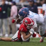 Oct 18, 2025; Athens, Georgia, USA; Georgia Bulldogs tight end Lawson Luckie (7) is brought down by Mississippi Rebels linebacker TJ Dottery (6) during the second quarter at Sanford Stadium. Mandatory Credit: Brett Davis-Imagn Images