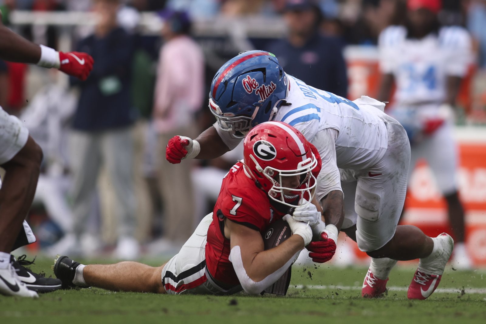 Oct 18, 2025; Athens, Georgia, USA; Georgia Bulldogs tight end Lawson Luckie (7) is brought down by Mississippi Rebels linebacker TJ Dottery (6) during the second quarter at Sanford Stadium. Mandatory Credit: Brett Davis-Imagn Images