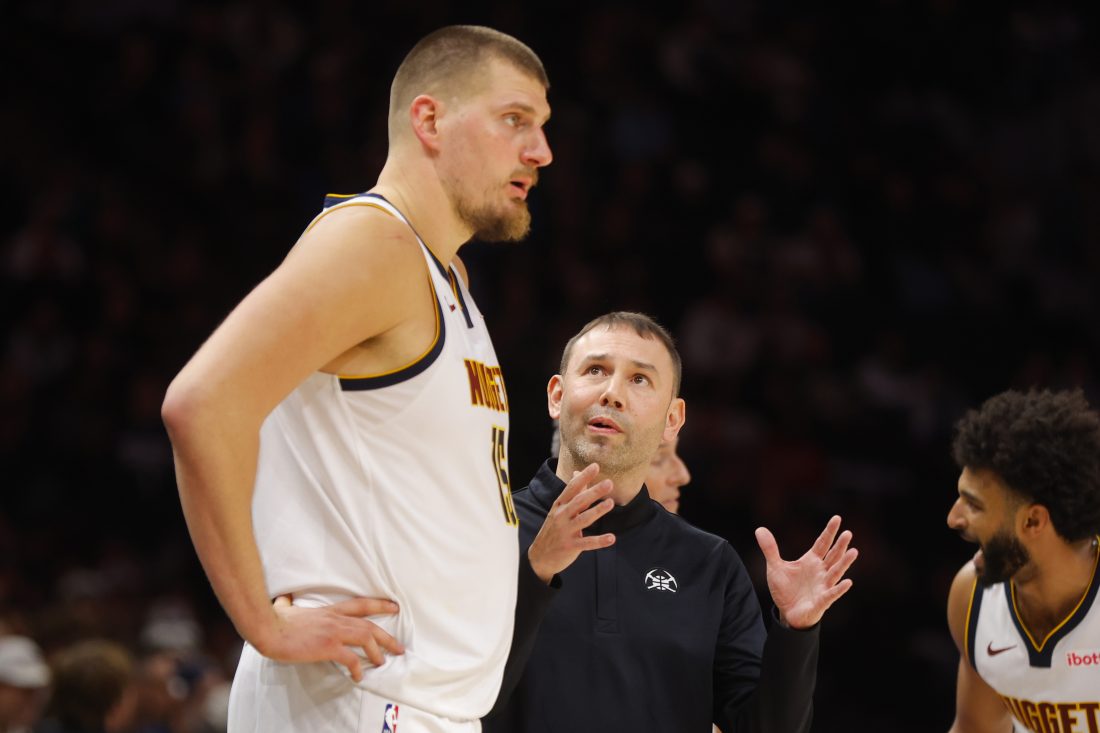 Oct 27, 2025; Minneapolis, Minnesota, USA; Denver Nuggets head coach David Adelman directs center Nikola Jokic (15) against the Minnesota Timberwolves in the fourth quarter at Target Center. Mandatory Credit: Bruce Kluckhohn-Imagn Images