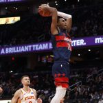 Nov 25, 2025; Washington, District of Columbia, USA; Washington Wizards center Alex Sarr (20) dunks the ball as Atlanta Hawks forward Zaccharie Risacher (10) looks on in the second half at Capital One Arena.