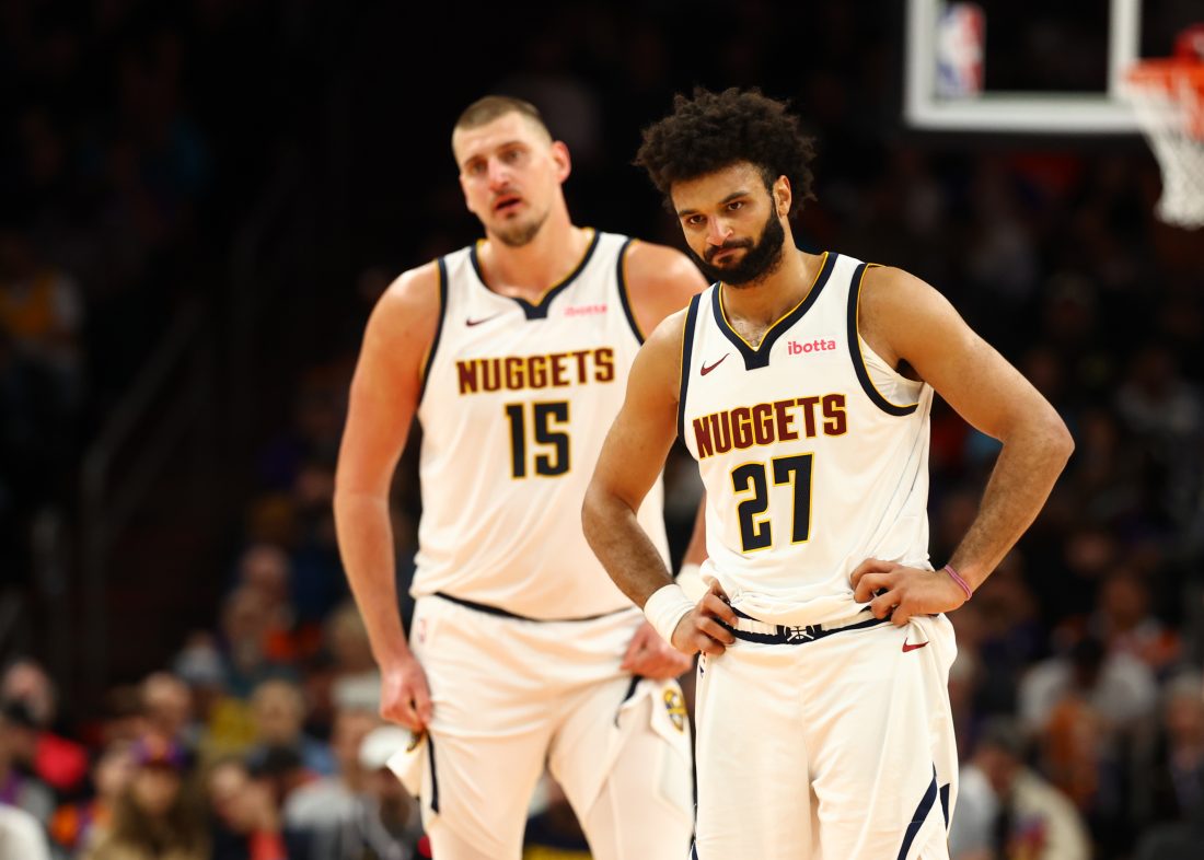 Nov 29, 2025; Phoenix, Arizona, USA; Denver Nuggets guard Jamal Murray (27) and center Nikola Jokic (15) against the Phoenix Suns at the Mortgage Matchup Center. Mandatory Credit: Mark J. Rebilas-Imagn Images