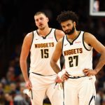 Nov 29, 2025; Phoenix, Arizona, USA; Denver Nuggets guard Jamal Murray (27) and center Nikola Jokic (15) against the Phoenix Suns at the Mortgage Matchup Center. Mandatory Credit: Mark J. Rebilas-Imagn Images