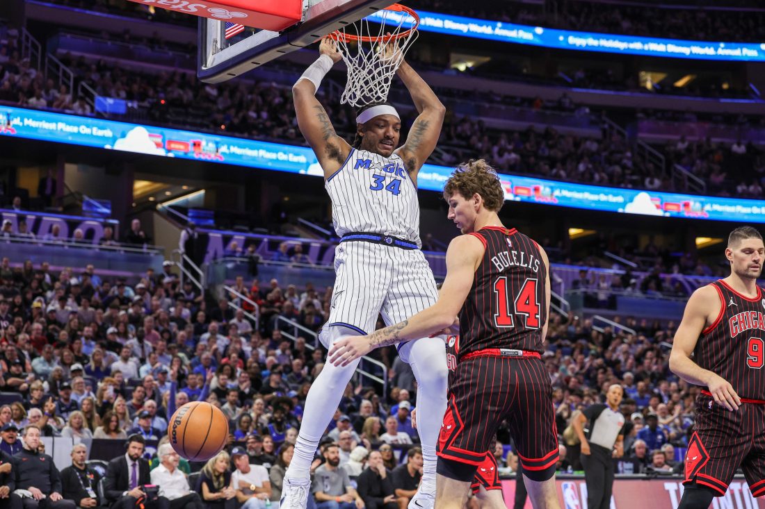 Dec 1, 2025; Orlando, Florida, USA; Orlando Magic center Wendell Carter Jr. (34) dunks in front of Chicago Bulls forward Matas Buzelis (14) during the first quarter at Kia Center. Mandatory Credit: Mike Watters-Imagn Images