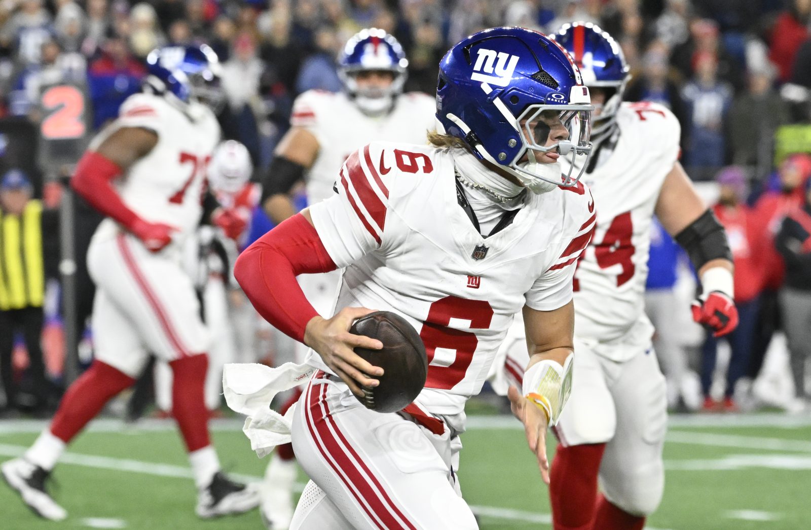 Dec 1, 2025; Foxborough, Massachusetts, USA; New York Giants quarterback Jaxson Dart (6) carries the ball during the first quarter against the New England Patriots at Gillette Stadium. Mandatory Credit: Eric Canha-Imagn Images