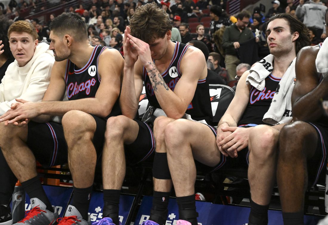 Dec 3, 2025; Chicago, Illinois, USA; Chicago Bulls forward Matas Buzelis (14), center, and guard Josh Giddey (3) after the second half against the Brooklyn Nets at the United Center. Mandatory Credit: Matt Marton-Imagn Images