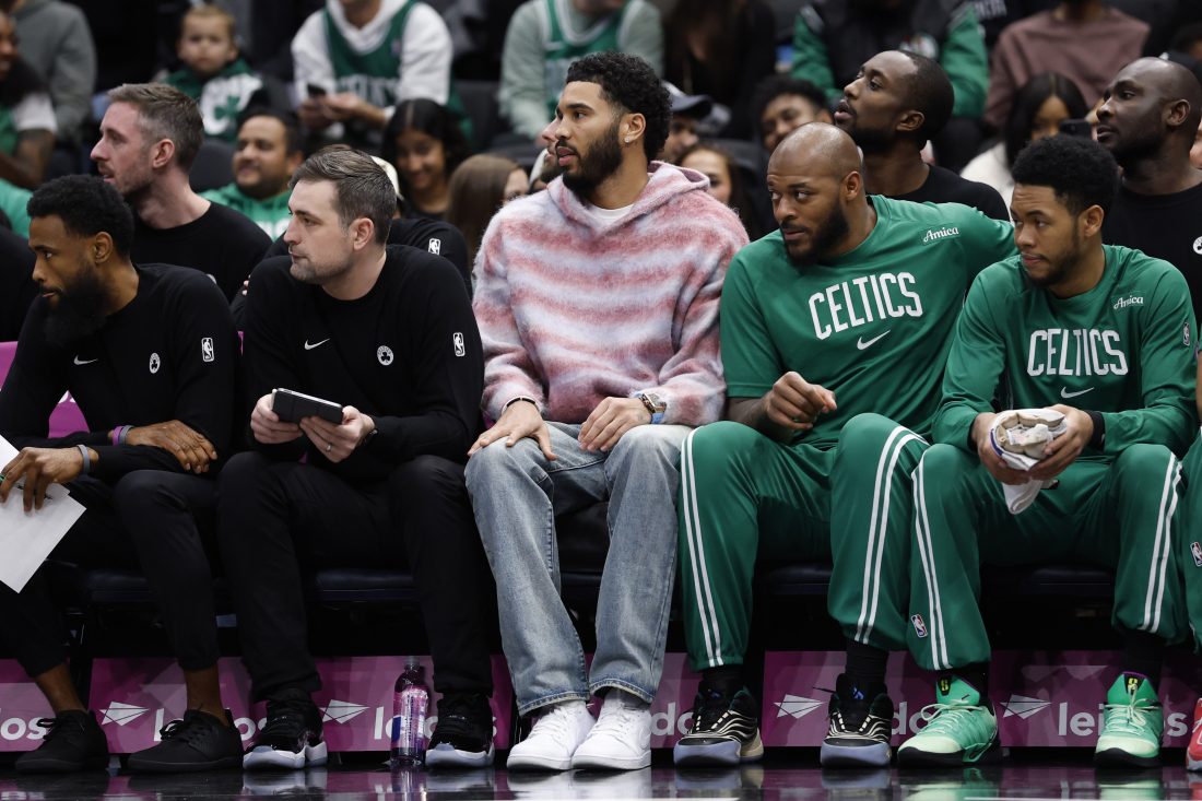 Dec 4, 2025; Washington, District of Columbia, USA; Injured Boston Celtics forward Jayson Tatum (M) looks on from the bench against the Washington Wizards in the first half at Capital One Arena. Mandatory Credit: Geoff Burke-Imagn Images