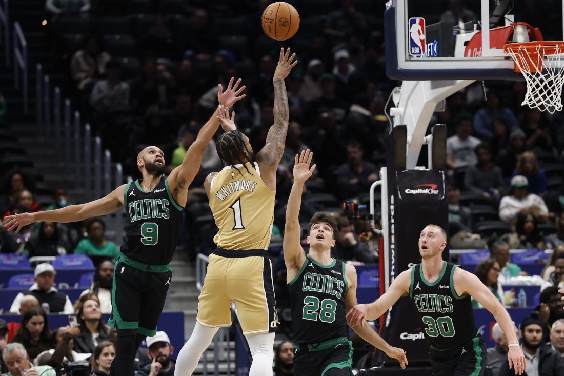 Dec 4, 2025; Washington, District of Columbia, USA; Washington Wizards forward Cam Whitmore (1) shoots the ball as Boston Celtics guard Derrick White (9) defends in the first half at Capital One Arena.