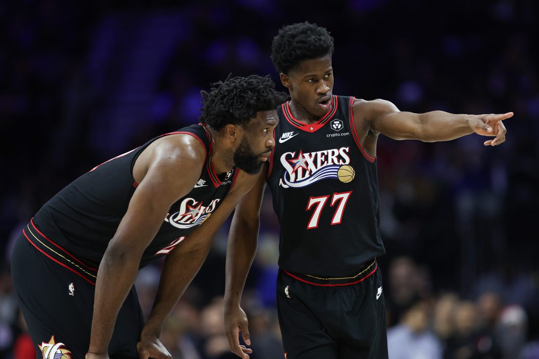 Dec 4, 2025; Philadelphia, Pennsylvania, USA; Philadelphia 76ers guard VJ Edgecombe (77) talks with center Joel Embiid (21) during the second quarter of a game against the Golden State Warriors at Xfinity Mobile Arena. Mandatory Credit: Bill Streicher-Imagn Images