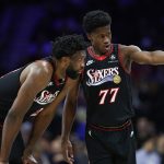 Dec 4, 2025; Philadelphia, Pennsylvania, USA; Philadelphia 76ers guard VJ Edgecombe (77) talks with center Joel Embiid (21) during the second quarter of a game against the Golden State Warriors at Xfinity Mobile Arena. Mandatory Credit: Bill Streicher-Imagn Images