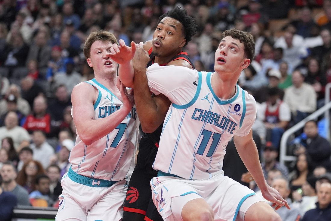 Dec 5, 2025; Toronto, Ontario, CAN; Charlotte Hornets guard Kon Knueppel (7) and center Ryan Kalkbrenner (11) block Toronto Raptors guard Scottie Barnes (4) out of a play during the first half at Scotiabank Arena.
