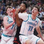 Dec 5, 2025; Toronto, Ontario, CAN; Charlotte Hornets guard Kon Knueppel (7) and center Ryan Kalkbrenner (11) block Toronto Raptors guard Scottie Barnes (4) out of a play during the first half at Scotiabank Arena.