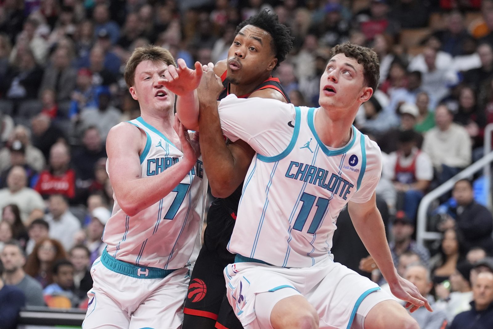 Dec 5, 2025; Toronto, Ontario, CAN; Charlotte Hornets guard Kon Knueppel (7) and center Ryan Kalkbrenner (11) block Toronto Raptors guard Scottie Barnes (4) out of a play during the first half at Scotiabank Arena.