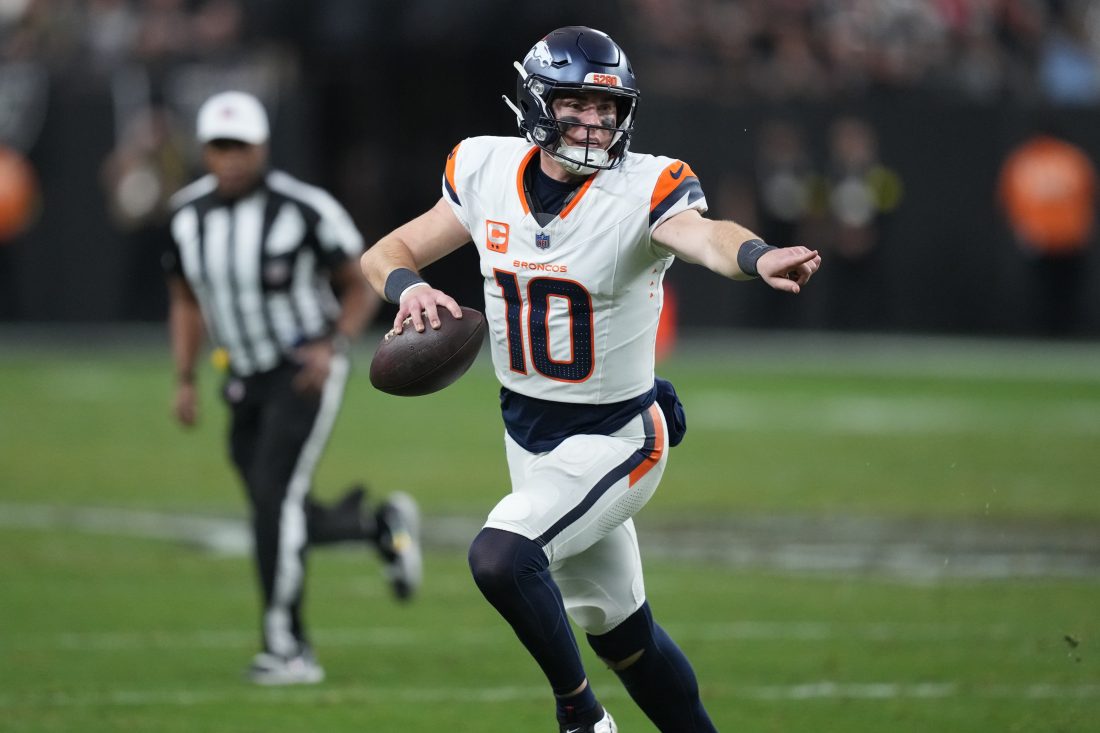 Dec 7, 2025; Paradise, Nevada, USA; Denver Broncos quarterback Bo Nix (10) scrambles against the Las Vegas Raiders during the second half at Allegiant Stadium. Mandatory Credit: Kirby Lee-Imagn Images