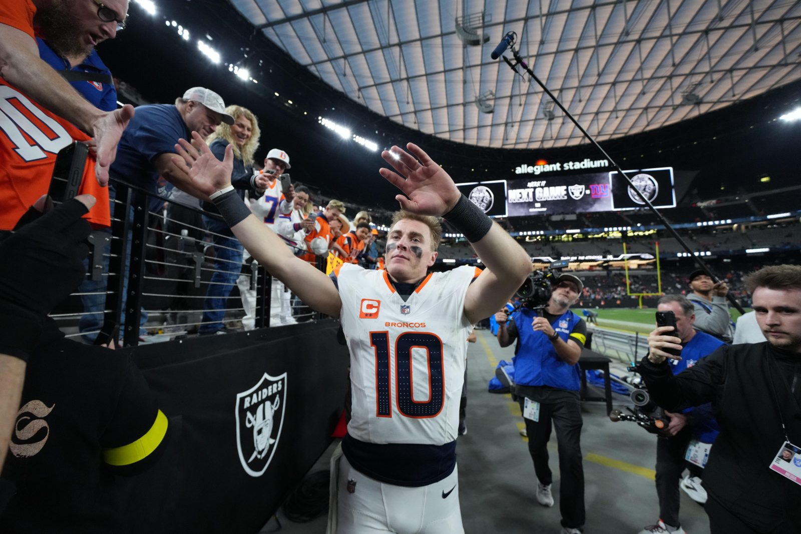 Dec 7, 2025; Paradise, Nevada, USA; Denver Broncos quarterback Bo Nix (10) high five fans following a game against the Las Vegas Raiders at Allegiant Stadium. Mandatory Credit: Kirby Lee-Imagn Images