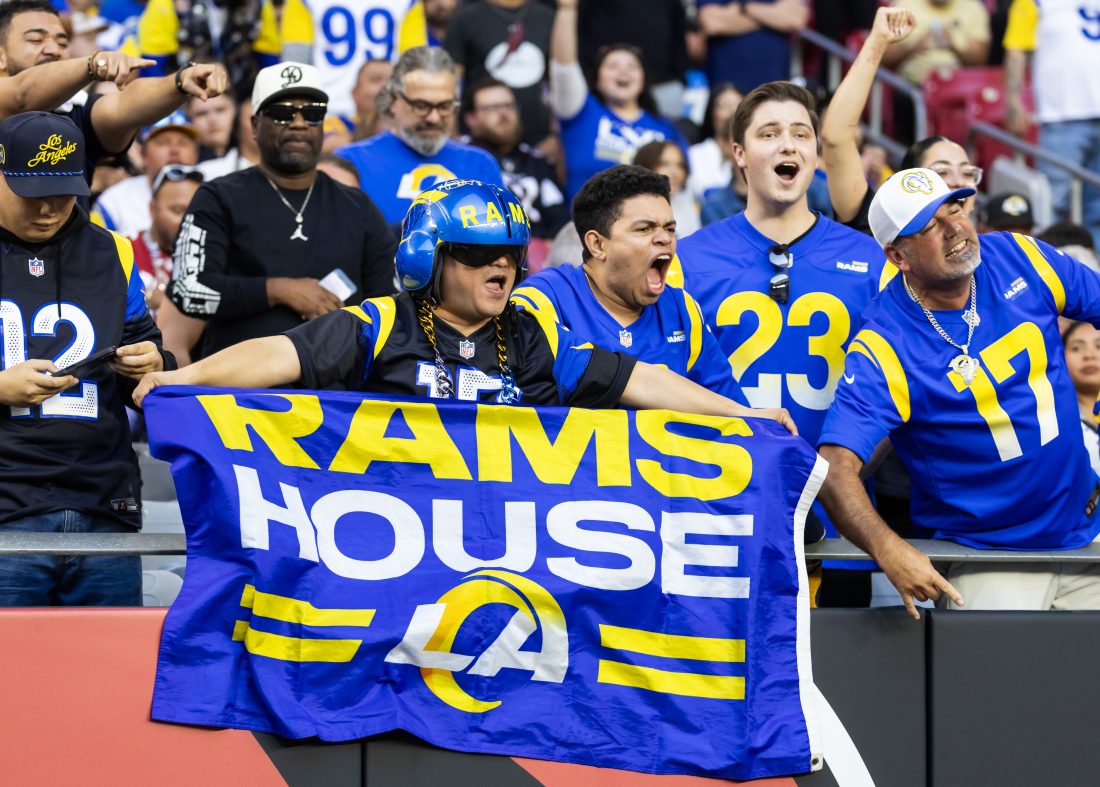 Dec 7, 2025; Glendale, Arizona, USA; Los Angeles Rams fans in the crowd celebrate a touchdown against the Arizona Cardinals during the second half at State Farm Stadium.