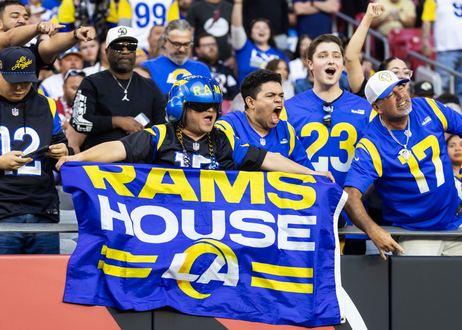 Dec 7, 2025; Glendale, Arizona, USA; Los Angeles Rams fans in the crowd celebrate a touchdown against the Arizona Cardinals during the second half at State Farm Stadium.