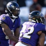 Baltimore Ravens quarterback Lamar Jackson (8) hands off the ball to Baltimore Ravens running back Derrick Henry (22) in the first quarter of the NFL football game at Paycor Stadium in Cincinnati on Dec. 14, 2025.
