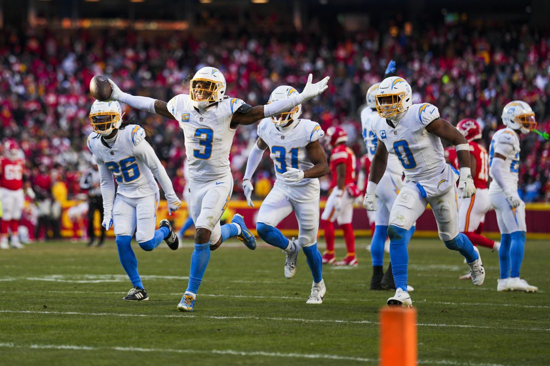 Dec 14, 2025; Kansas City, Missouri, USA; Los Angeles Chargers safety Derwin James Jr. (3) celebrates with cornerback Donte Jackson (26) and linebacker Daiyan Henley (0) following an interception against the Kansas City Chiefs during the fourth quarter at GEHA Field at Arrowhead Stadium. Mandatory Credit: Jay Biggerstaff-Imagn Images