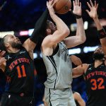 Dec 16, 2025; Las Vegas, Nevada, USA; New York Knicks guard Jalen Brunson (11), center Karl-Anthony Towns (32) attempt to block the shot of San Antonio Spurs center Luke Kornet (7) during the Emirates NBA Cup Final at T-Mobile Arena. Mandatory Credit: Kirby Lee-Imagn Images