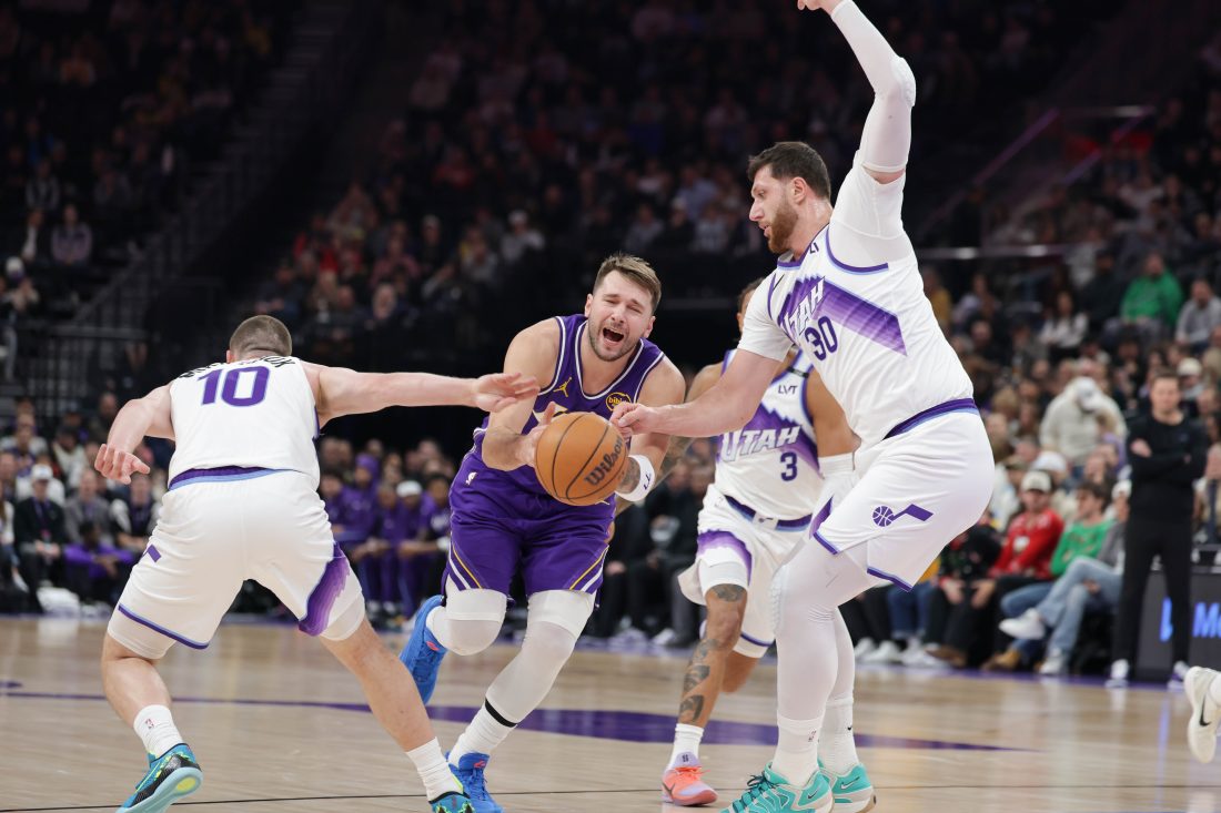 Dec 18, 2025; Salt Lake City, Utah, USA; Los Angeles Lakers forward/guard Luka Doncic (77) is fouled by Utah Jazz guard/forward Svi Mykhailiuk (10) during the first quarter at Delta Center.