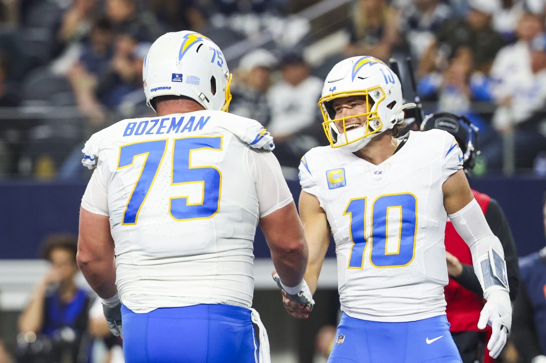 Dec 21, 2025; Arlington, Texas, USA; Los Angeles Chargers quarterback Justin Herbert (10) celebrates with center Bradley Bozeman (75) after rushing for a touchdown against the Dallas Cowboys during the second quarter at AT&T Stadium. Mandatory Credit: Kevin Jairaj-Imagn Images