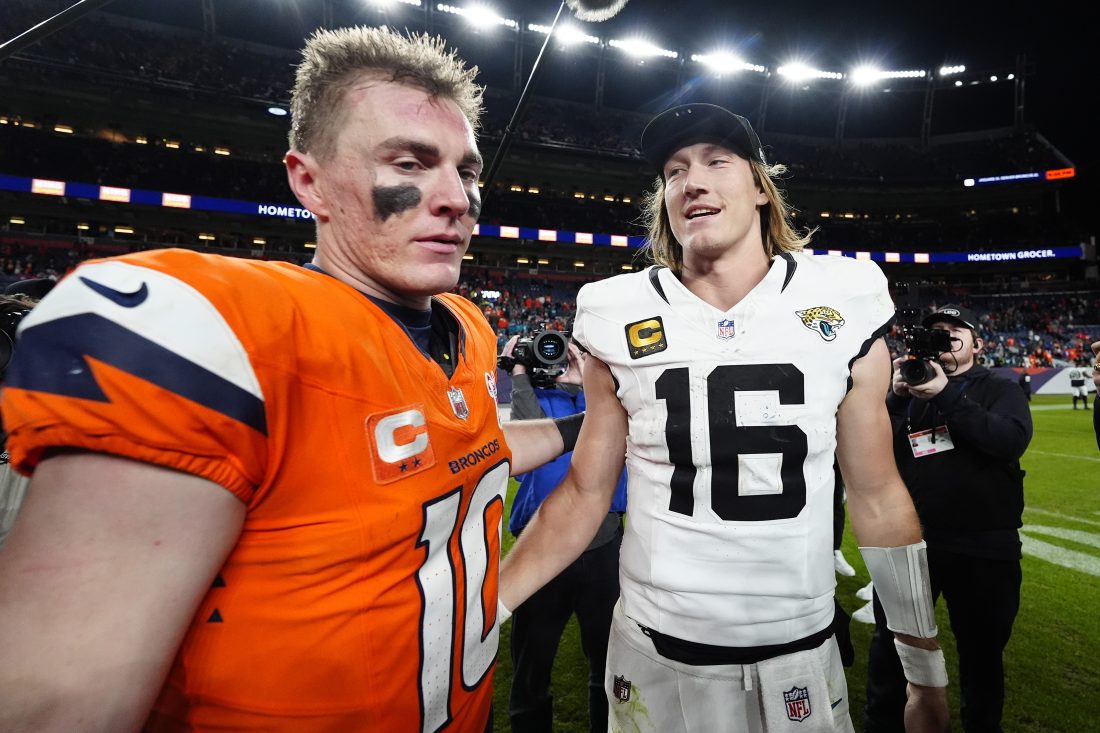 Dec 21, 2025; Denver, Colorado, USA; Denver Broncos quarterback Bo Nix (10) and Jacksonville Jaguars quarterback Trevor Lawrence (16) meet after the game at Empower Field at Mile High. Mandatory Credit: Ron Chenoy-Imagn Images