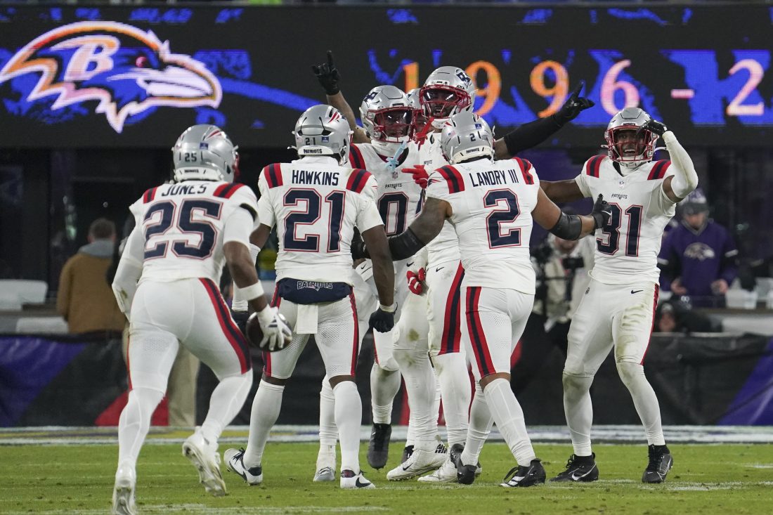 Dec 21, 2025; Baltimore, Maryland, USA; New England Patriots cornerback Marcus Jones (25) celebraets a fumble recovery with teammates during the second half of the game against the Baltimore Ravens at M&T Bank Stadium. Mandatory Credit: James Lang-Imagn Images