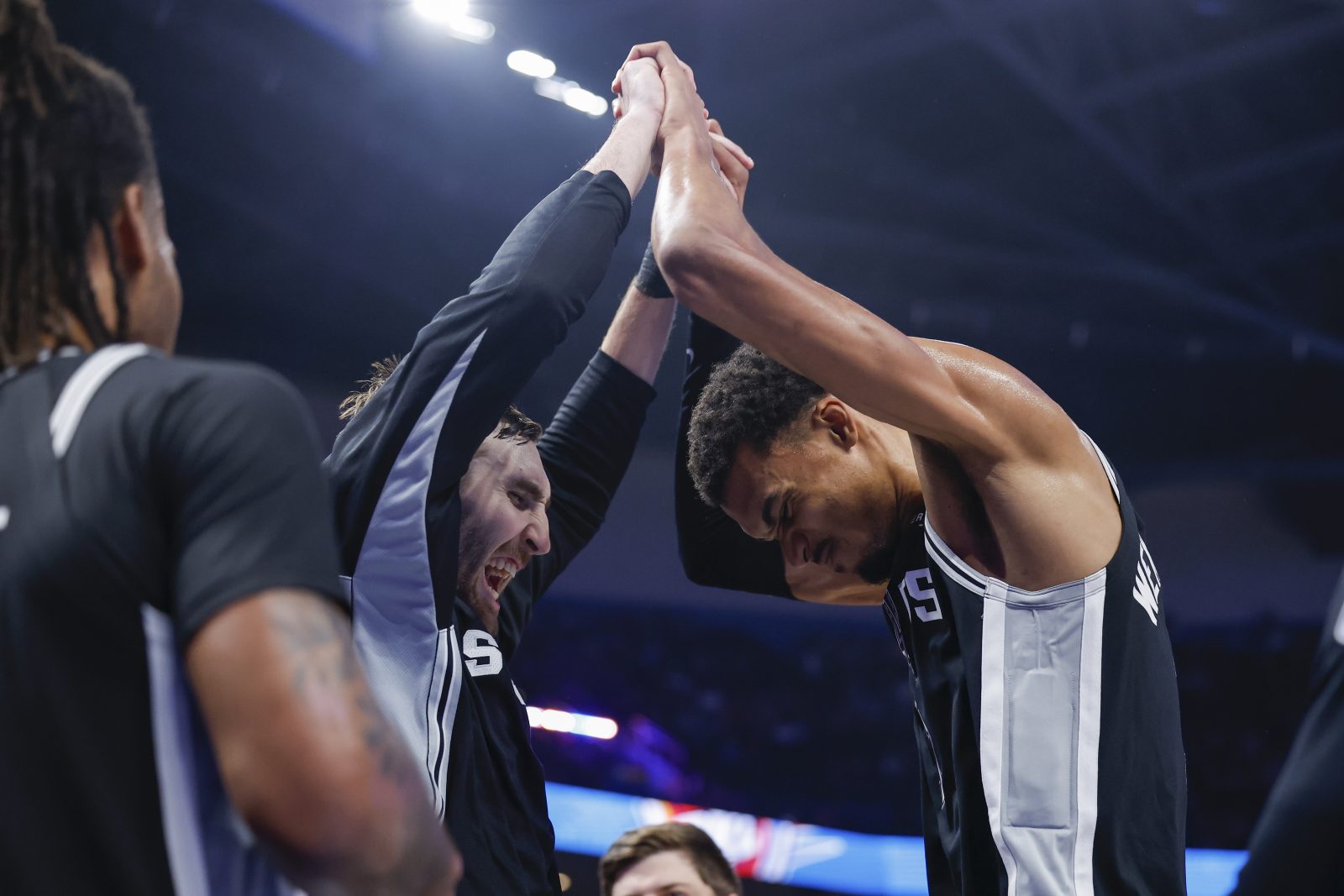 Dec 25, 2025; Oklahoma City, Oklahoma, USA; San Antonio Spurs forward Victor Wembanyama (1) and center Luke Kornet (7) celebrate at the end of the fourth quarter against the Oklahoma City Thunder at Paycom Center.