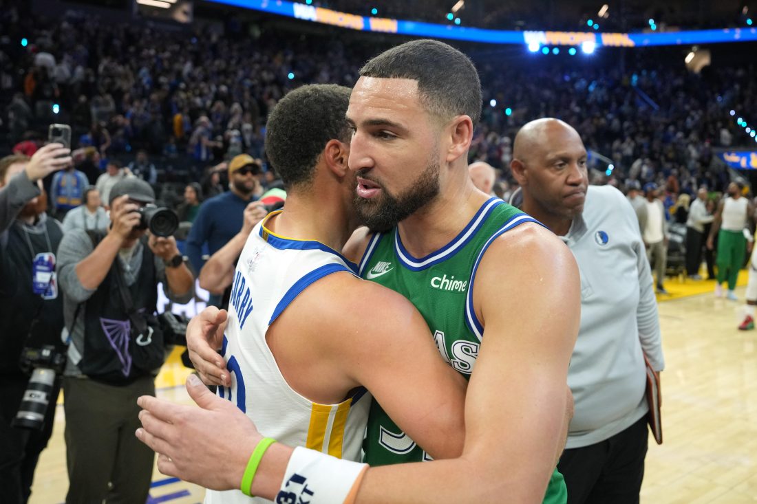 Dec 25, 2025; San Francisco, California, USA; Golden State Warriors guard Stephen Curry (center left) and Dallas Mavericks guard Klay Thompson (center right) greet each other after the game at Chase Center. Mandatory Credit: Darren Yamashita-Imagn Images