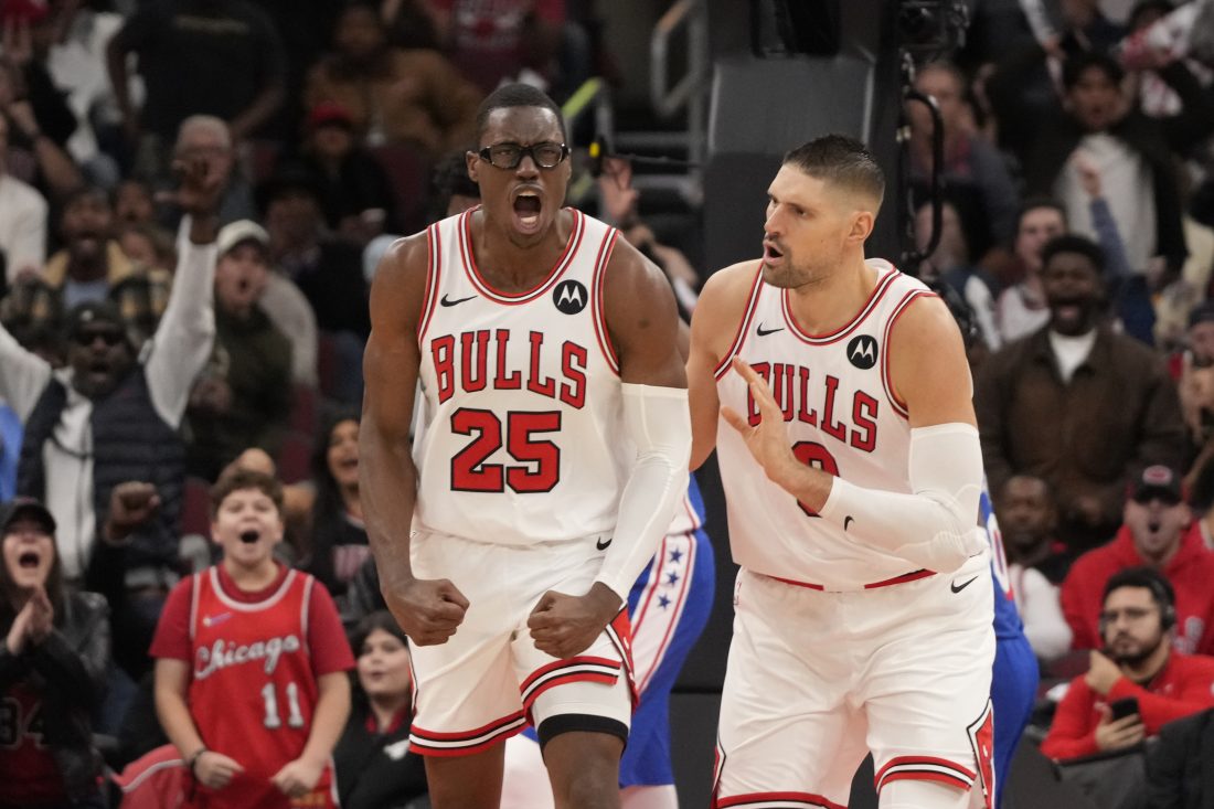 Dec 26, 2025; Chicago, Illinois, USA; Chicago Bulls forward Jalen Smith (25) gestures after dunking the ball against the Philadelphia 76ers as center Nikola Vucevic (9) stands nearby during the second half at United Center. Mandatory Credit: David Banks-Imagn Images