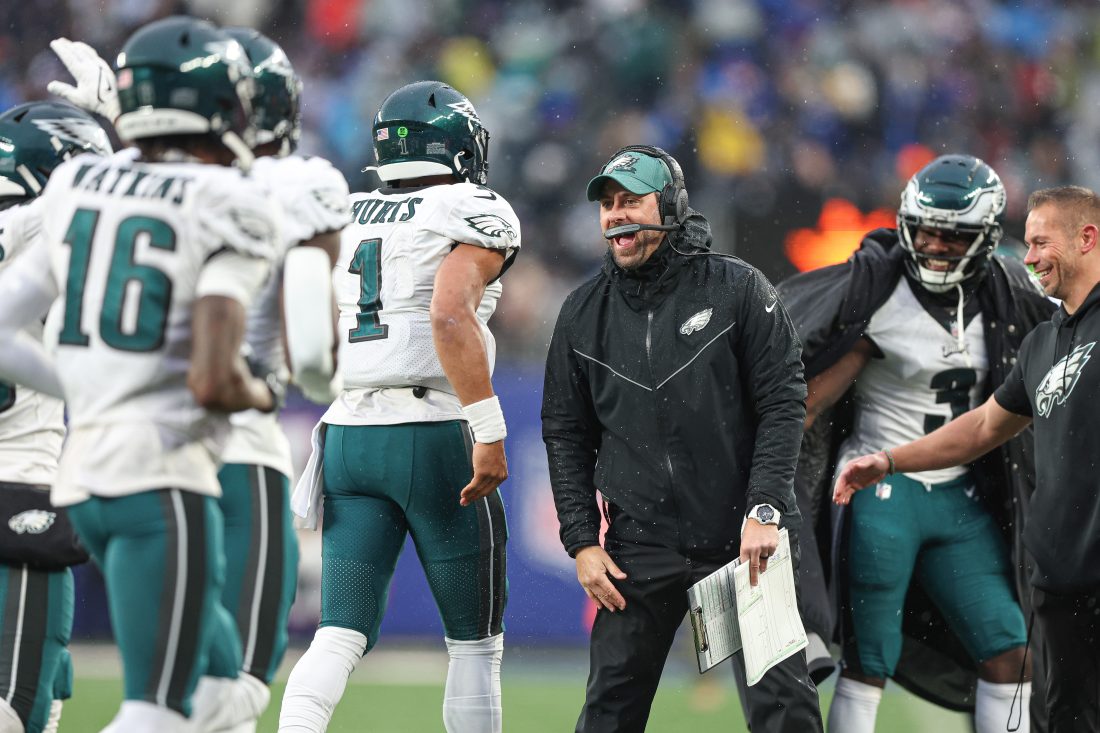 Dec 11, 2022; East Rutherford, New Jersey, USA; Philadelphia Eagles assistant coach Kevin Patullo celebrates with quarterback Jalen Hurts (1) after a touchdown during the second half against the New York Giants at MetLife Stadium.