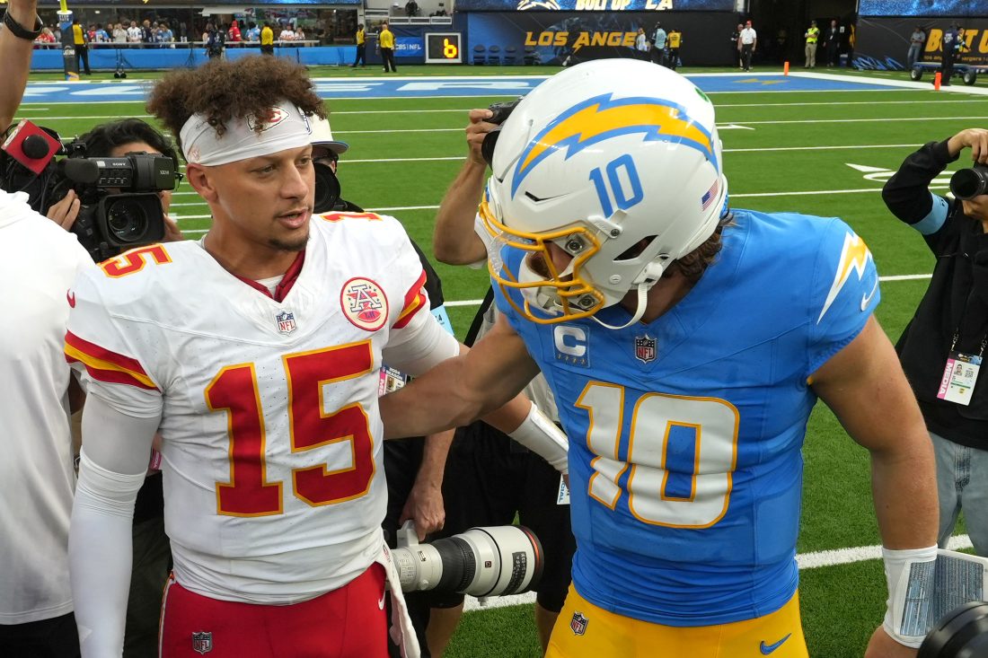 Sep 29, 2024; Inglewood, California, USA; Kansas City Chiefs quarterback Patrick Mahomes (15) and Los Angeles Chargers quarterback Justin Herbert (10) shake hands after the game at SoFi Stadium. Mandatory Credit: Kirby Lee-Imagn Images