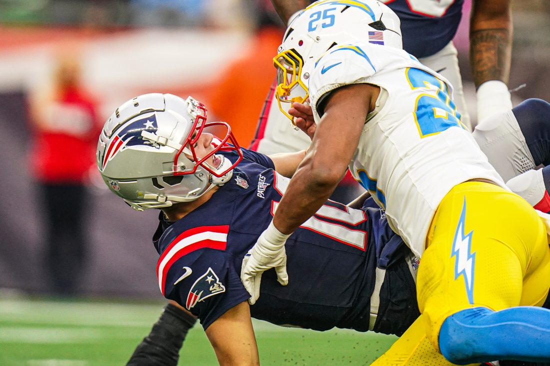 Dec 28, 2024; Foxborough, Massachusetts, USA; New England Patriots quarterback Drake Maye (10) on the field against Los Angeles Chargers linebacker Junior Colson (25) second half at Gillette Stadium. Mandatory Credit: David Butler II-Imagn Images