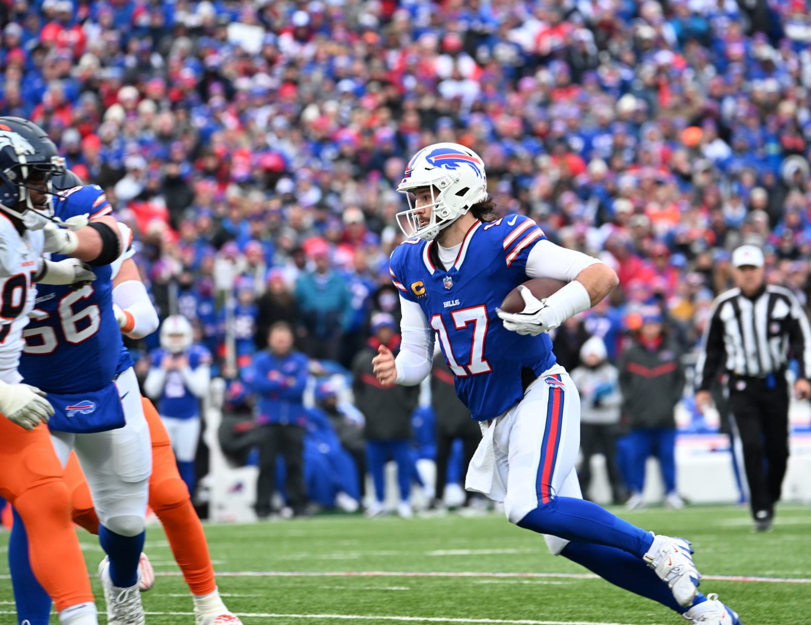 Jan 12, 2025; Orchard Park, New York, USA; Buffalo Bills quarterback Josh Allen (17) moves in the pocket against the Denver Broncos during the second quarter in an AFC wild card game at Highmark Stadium. Mandatory Credit: